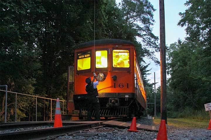 At Midway, Rich Fischpera puts up the pole by lantern light as P&W 161 prepares for its return run to the New York Museum of Transportation.